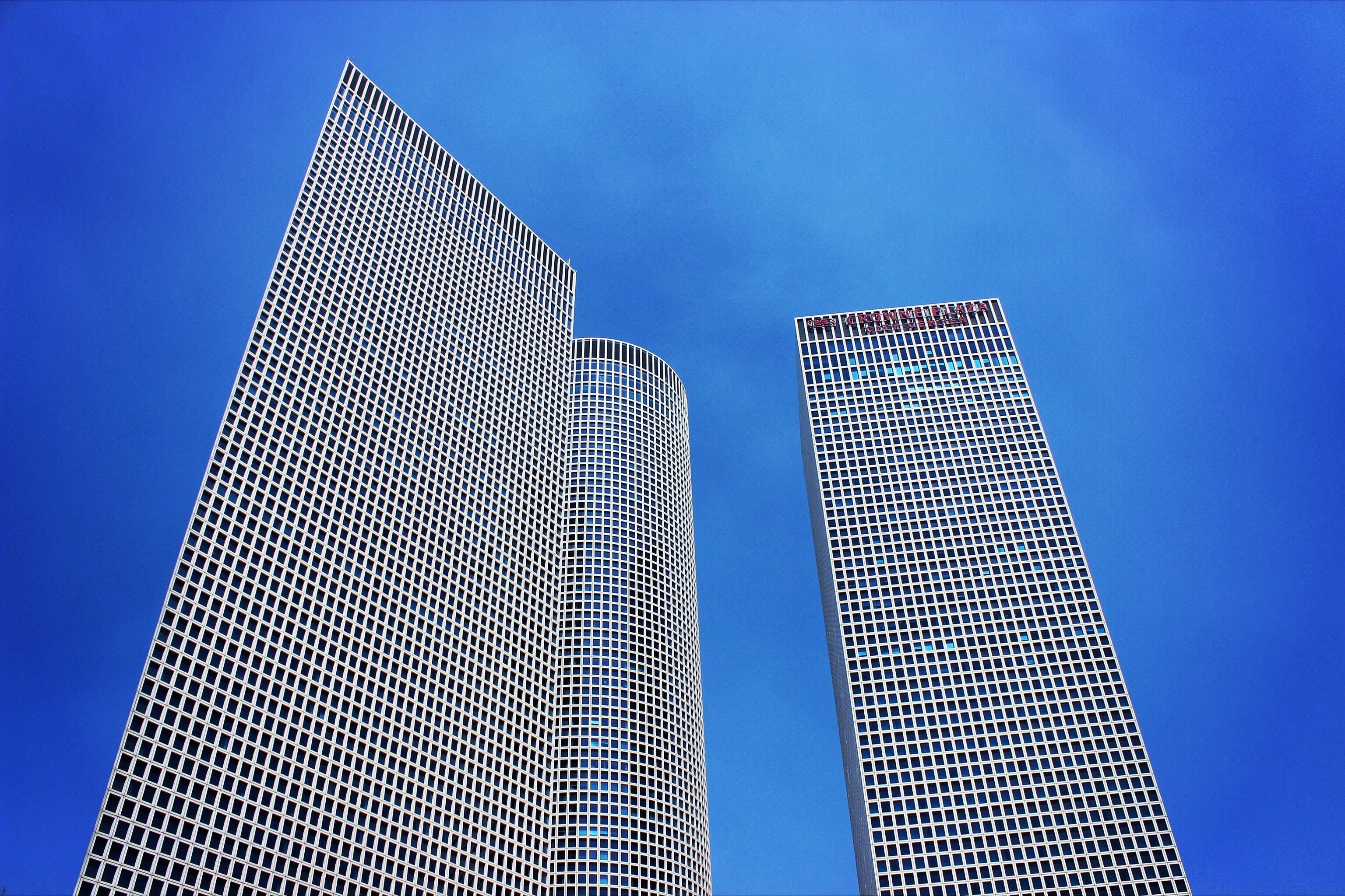 low-angle photography of three high-rise buildings